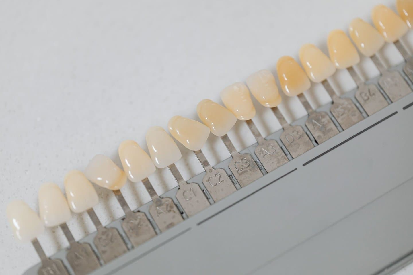 A dental shade guide showing a range of tooth color tones