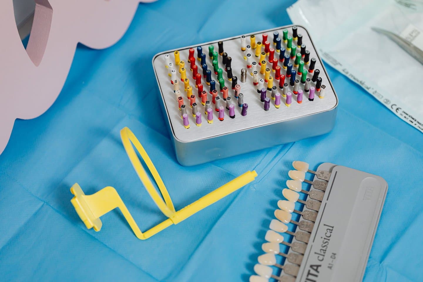 Color-coded endodontic files and a tooth shade guide used in root canal treatment